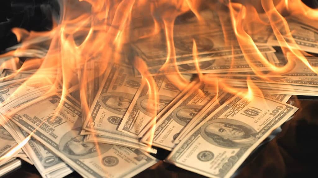 image description: a pile of burning money