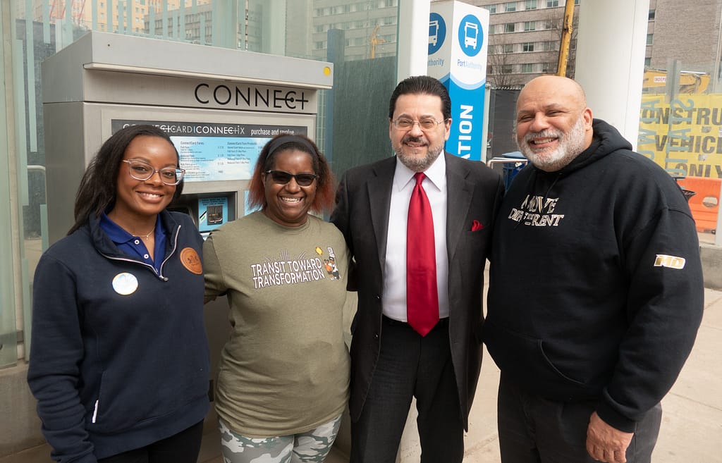 John Weinstein smiling with PPT Ride-along delegation in front of a CONNECTCard machine at the Atwood bus stop in the Oakland neighborhood of Pittsburgh