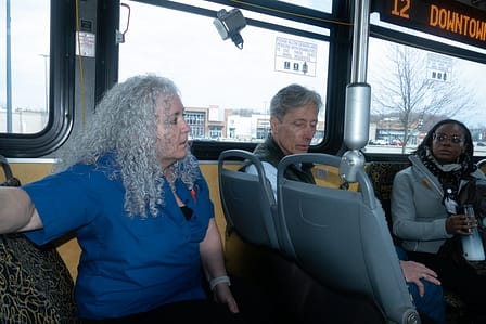 PRT operator Sue Scanlon (right) leans forward in her on the 12 McKnight bus  discusses driver issues with David Fawcett listening in (middle).